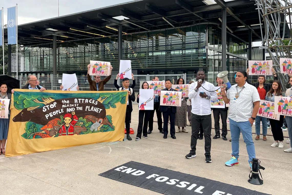 FILE PHOTO: Activists hold an anti-fossil fuel protest at the pre-cop28 climate conference, in front of the United Nations building in Bonn, Germany, June 7, 2023.     REUTERS/Riham Alkousaa/File Photo