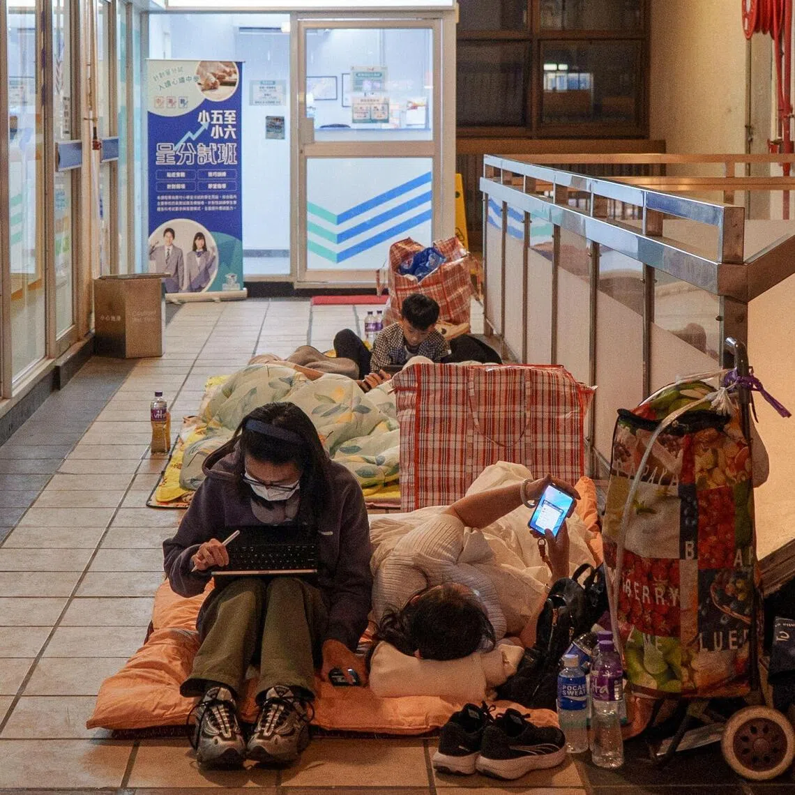 Victims of a massive blaze that gutted the Wang Fuk Court apartment complex take shelter inside a shopping mall.