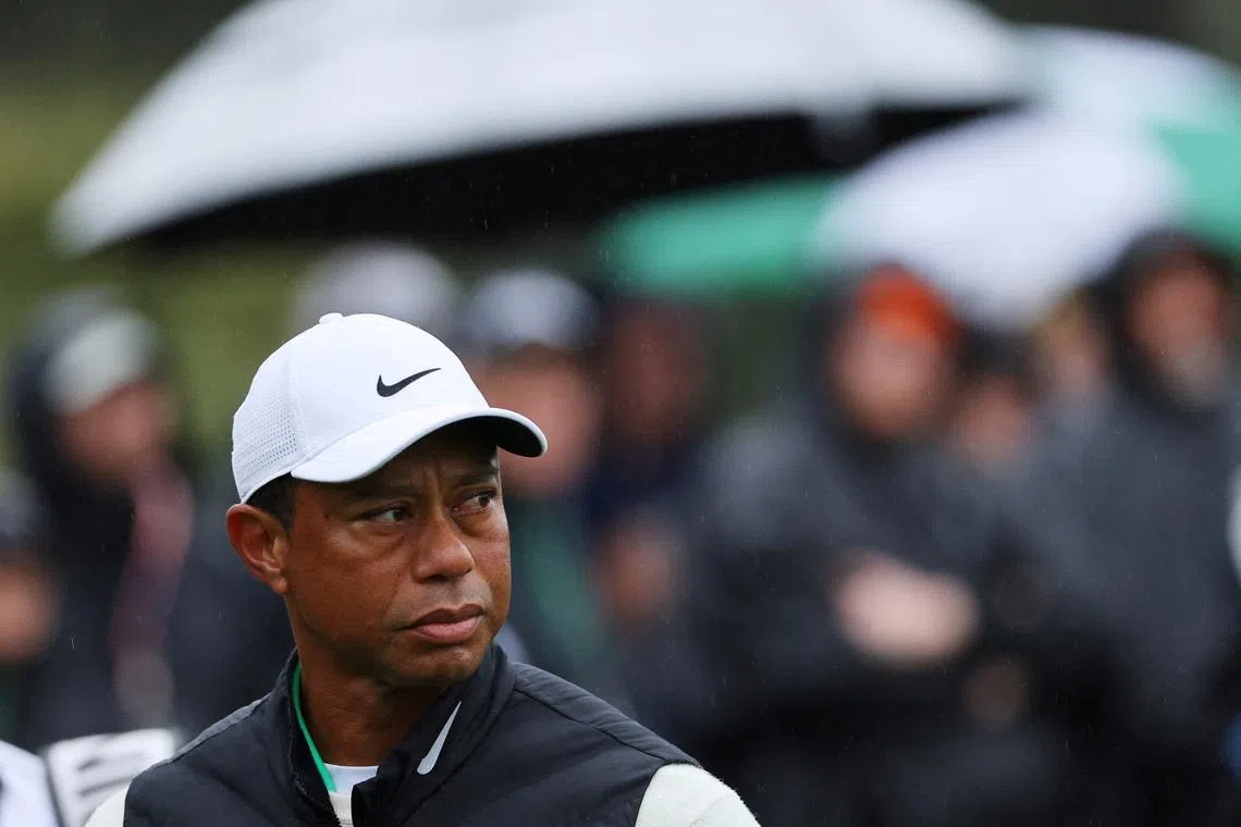 FILE PHOTO: Golf - The Masters - Augusta National Golf Club - Augusta, Georgia, U.S. - April 8, 2023 Tiger Woods of the U.S. reacts after holing his bogey putt on the 17th green during the second round REUTERS/Mike Blake/File Photo