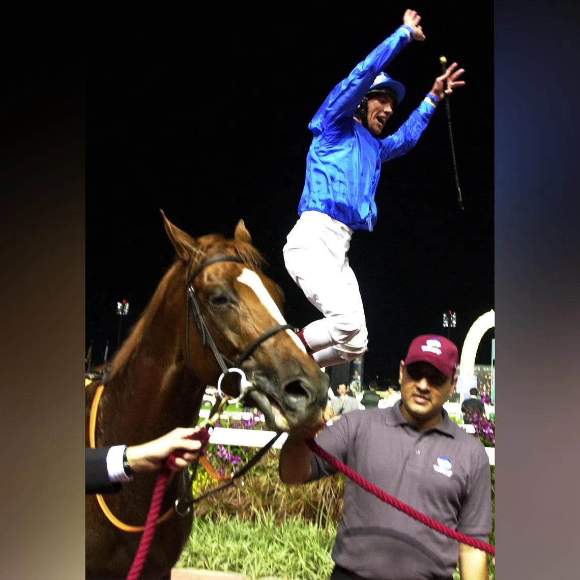Frankie Dettori leaping off Grandera after their win in the Group 1 Singapore Airlines International Cup (2,000m) at Kranji in 2002.