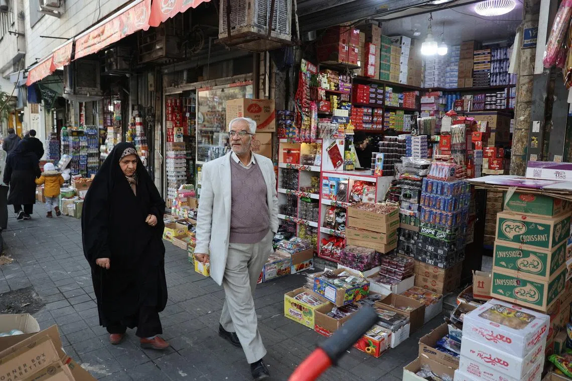 People walk on a street, as protests erupt over the collapse of the currency's value, in Tehran, Iran, January 5, 2026. Majid Asgaripour/WANA (West Asia News Agency) via REUTERS