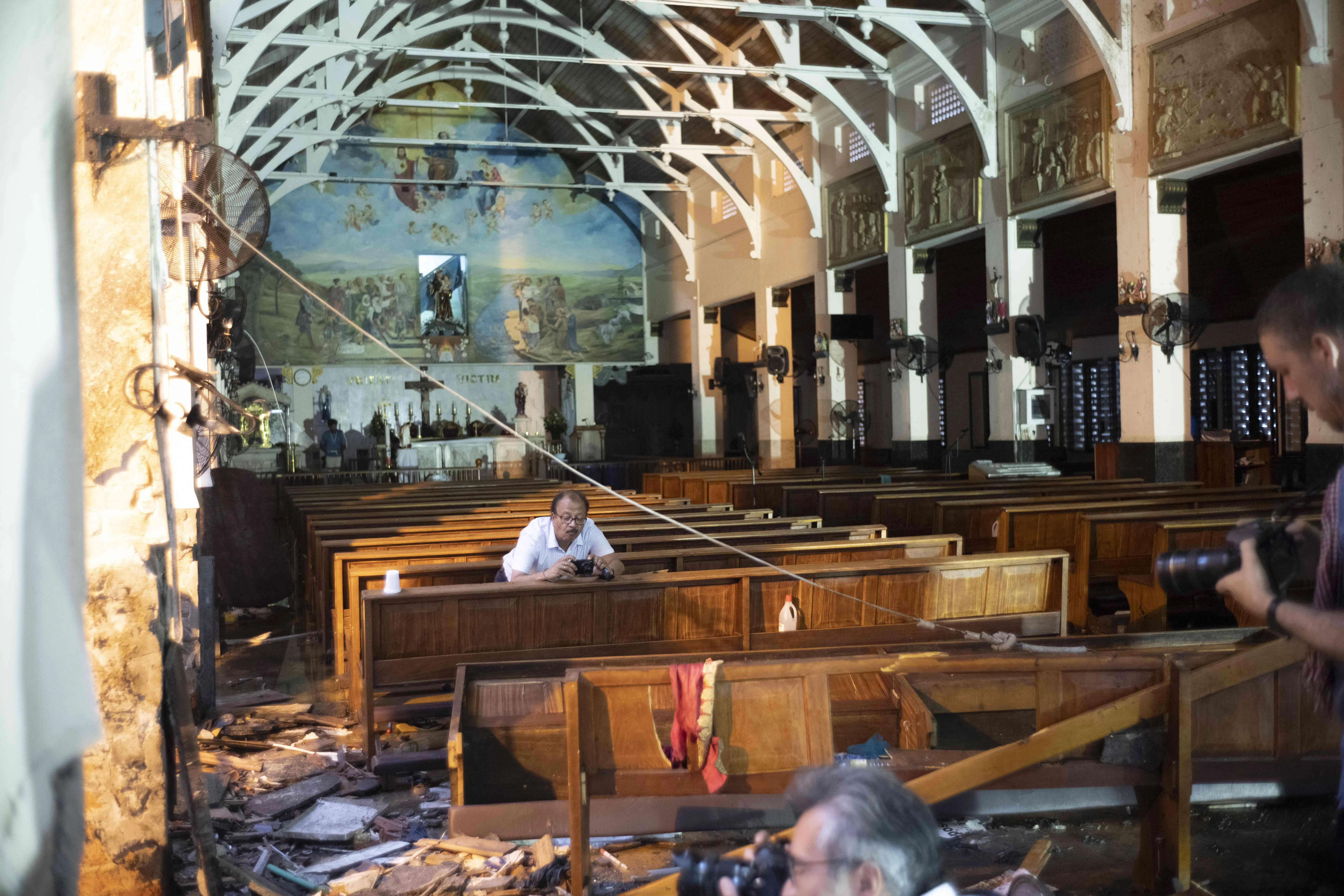 A 2019 photo shows journalists taking pictures at St Anthony’s Shrine in Colombo after the attacks.
