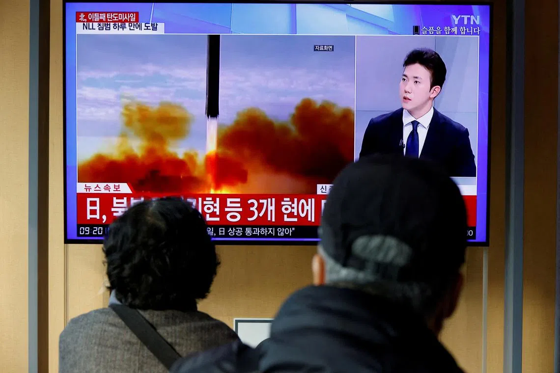 People in Seoul watch a news report on North Korea firing a ballistic missile off its east coast.