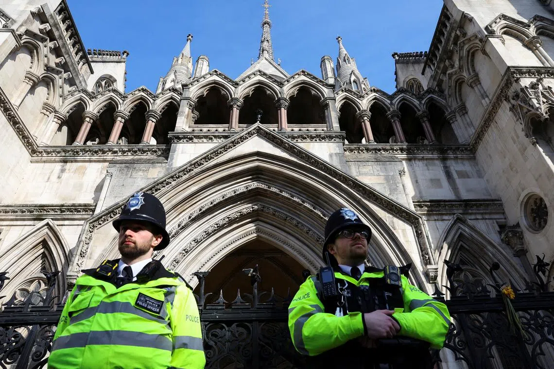 FILE PHOTO: Police officers stand guard outside the High Court in London, Britain, March 26, 2024. REUTERS/Toby Melville/File Photo
