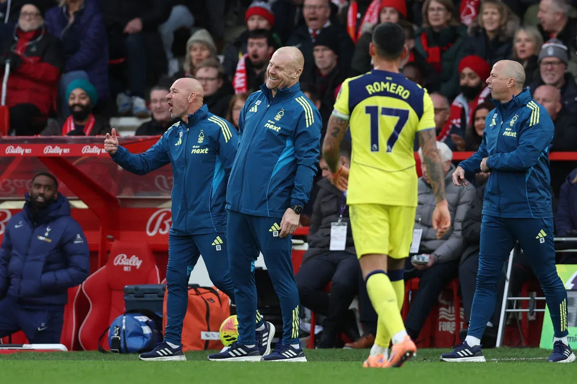 Soccer Football - Premier League - Nottingham Forest v Tottenham Hotspur - The City Ground, Nottingham, Britain - December 14, 2025 Nottingham Forest manager Sean Dyche and assistant managers Steve Stone and Ian Woan react REUTERS/Chris Radburn