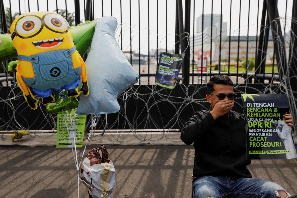 A man protesting against the new legislation which outlaws sex outside marriage, outside the Parliament buildings in Jakarta on Tuesday.