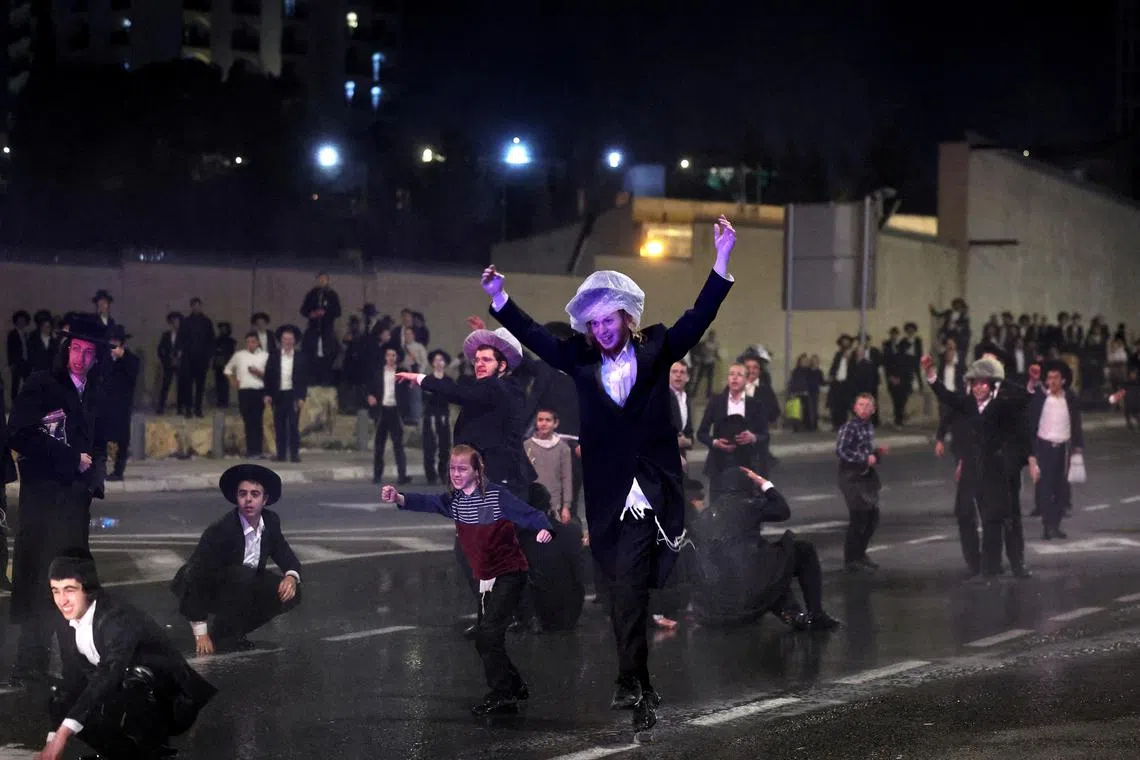 FILE PHOTO: Ultra-Orthodox Jewish men protest against attempts to change government policy that grants ultra-Orthodox Jews exemptions from military conscription in Jerusalem February 26, 2024. REUTERS/Ronen Zvulun/File Photo
