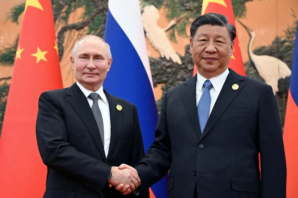 FILE PHOTO: Russian President Vladimir Putin shakes hands with Chinese President Xi Jinping during a meeting at the Belt and Road Forum in Beijing, China, October 18, 2023. Sputnik/Sergei Guneev/Pool via REUTERS/File Photo