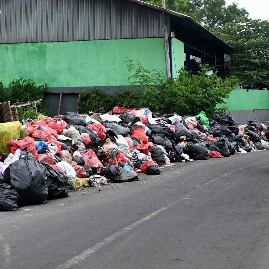 Rubbish has piled up on the streets of Denpasar in Bali.