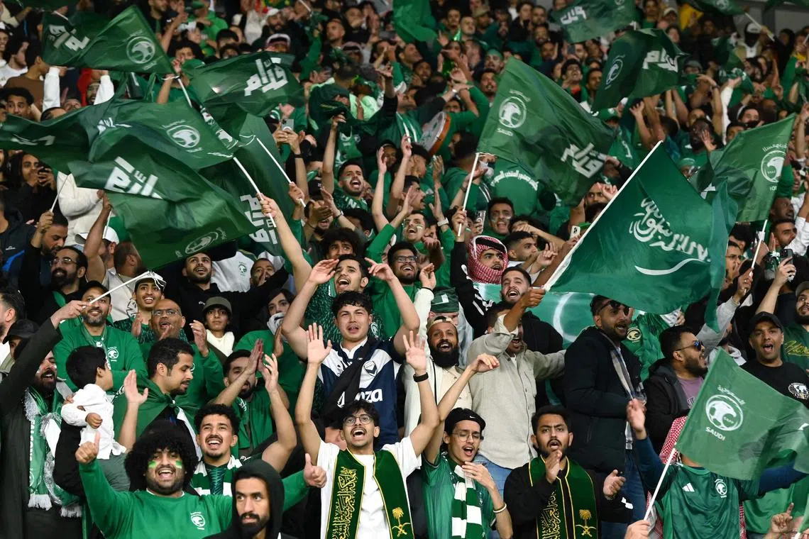 Supporters of Saudi Arabia react during a 2026 World Cup qualifying match against Australia.
