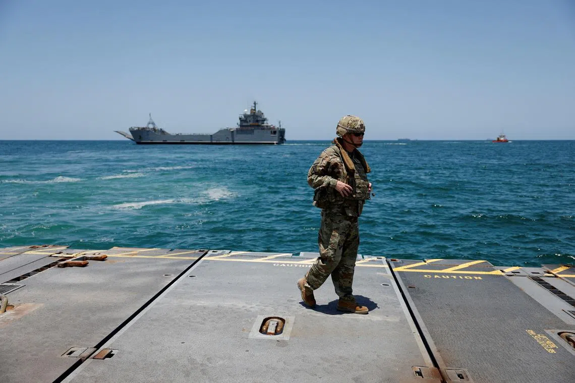 FILE PHOTO: A soldier stands at Trident Pier, a temporary pier to deliver aid, off the Gaza Strip, amid the ongoing conflict between Israel and Hamas, near the Gaza coast, June 25, 2024. REUTERS/Amir Cohen/File Photo