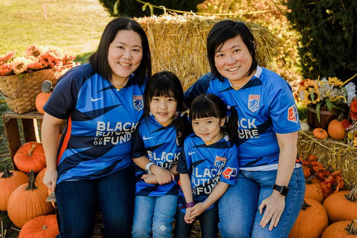 Same-sex parents Olivia (L) and Irene and their daughters Zoey (2nd L), 8, and Vicky, 4, pose for photos during Halloween at Swans Trail Farm, a pumpkin patch in Snohomish, Washington, U.S., October 2021. Olivia and Irene Chiong/Handout via REUTERS THIS IMAGE HAS BEEN SUPPLIED BY A THIRD PARTY. MANDATORY CREDIT. NO RESALES. NO ARCHIVES