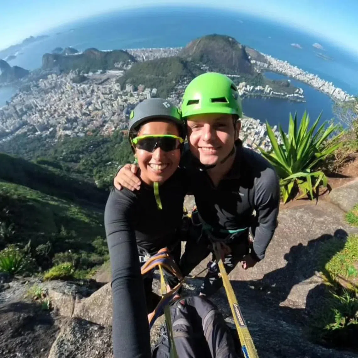 vltravel - Sunlife feature on travelling with a purpose: Ms Michelle Verma, 39, and her husband Mariusz Kozlowski, 35, combine sight-seeing with rock-climbing. Climbing together strengthens their bond and helps them connect with local guides. They are pictured here in August 2024, dangling 710m above ground, climbing to the summit at Mount Corcovado, Rio de Janeiro, Brazil, where the famous colossal Christ the Redeemer statue is located.

PHOTO COURTESY OF: Michelle Verma
(One time use)