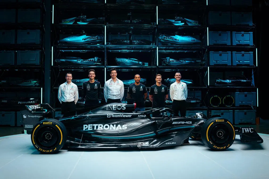 The Mercedes team posing with their new W14 car in Silverstone on Feb 15, 2023. 