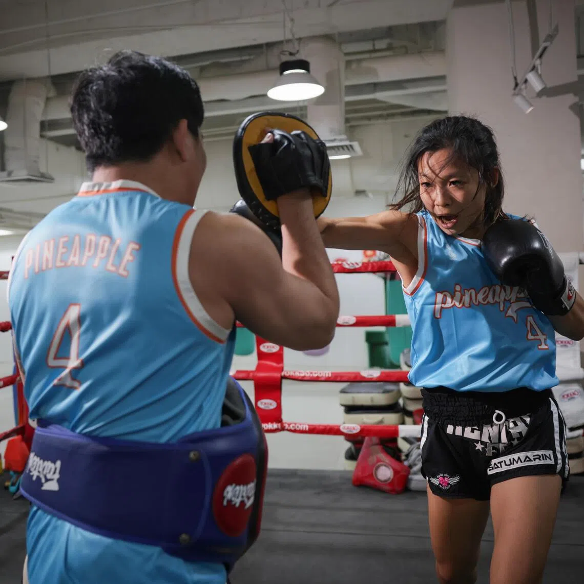 202583200491: Gin Tay/ kkmuay22/ Kimberly Kwek /
Singapore muay thai fighter Winnia Leow, (right) 26, in a training session at Pineapple MMA in Selegie on Dec 22, 2025.