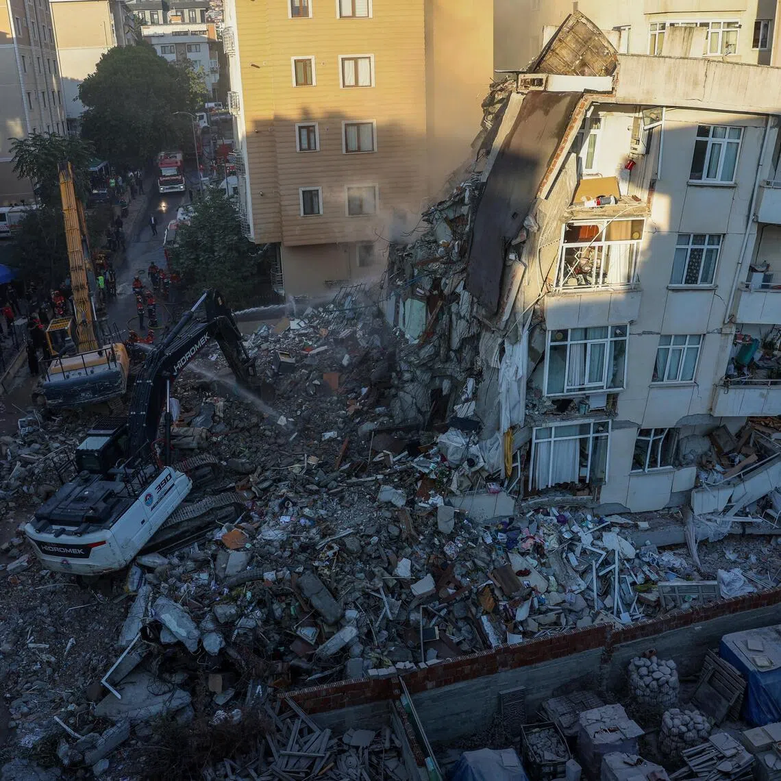 A partially collapsed building is demolished in an effort to reach any remaining people believed to be trapped inside in Istanbul, Turkey, on Oct 8.