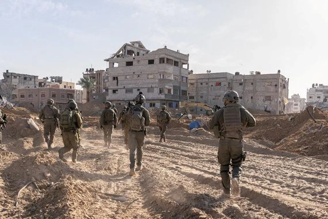 Israeli soldiers operate in the Gaza Strip, amid the ongoing conflict between Israel and the Palestinian Islamist group Hamas, in this handout picture released on January 20, 2024. Israel Defense Forces/Handout via REUTERS