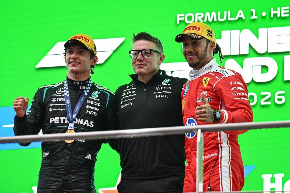 From left: Chinese Grand Prix winner Kimi Antonelli with Mercedes race engineer Peter Bonnington and Ferrari's Lewis Hamilton on the podium on March 15.