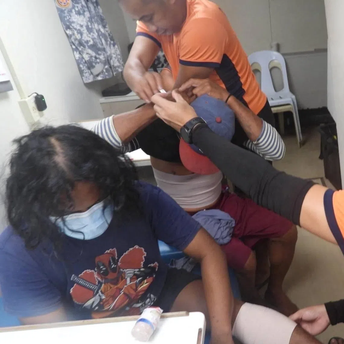 Philippine coast guard personnel attending to injured fishermen after Chinese coast guard ships used water cannon and cut the fishermen's anchor lines near Sabina ​Shoal ​on Dec 12.