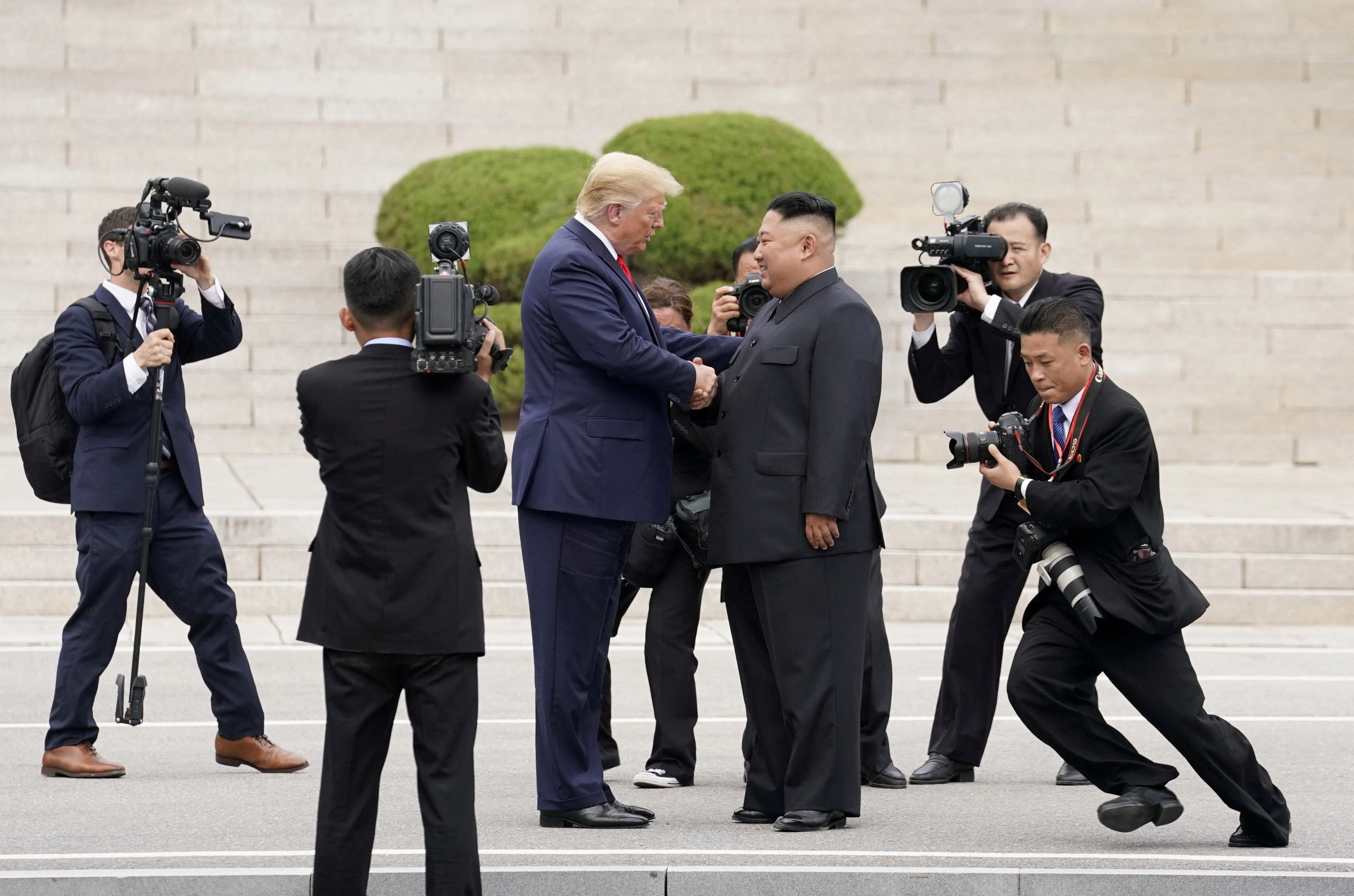 FILE PHOTO: U.S. President Donald Trump meets with North Korean leader Kim Jong Un at the demilitarized zone separating the two Koreas, in Panmunjom, South Korea, June 30, 2019. REUTERS/Kevin Lamarque/File Photo