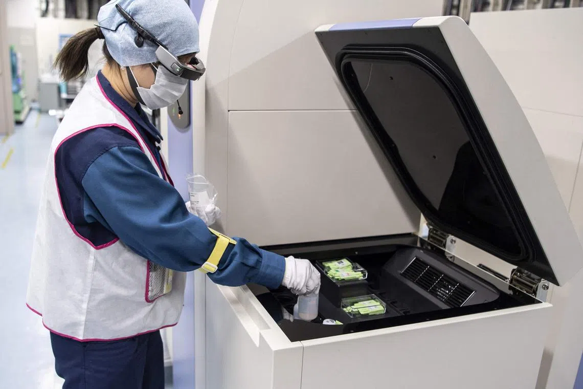 (FILES) This file picture taken on March 5, 2022 shows an employee conducting a tritium measurement on a sample of contaminated water at the Tokyo Electric Power Company (TEPCO) Fukushima Daiichi nuclear power plant in Okuma, Fukushima prefecture. Some 12 years after one of the world's worst nuclear disasters, Japan's premier said on August 22, 2023 the release of cooling water from the crippled Fukushima nuclear plant into the Pacific will begin on August 24, despite opposition from fishermen and protests by China. (Photo by Charly TRIBALLEAU / AFP)