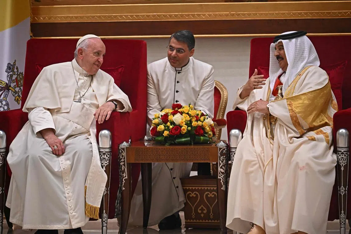 Pope Francis (L) speaks with Bahrain's King Hamad bin Isa al-Khalifa (R) during their meeting in Awali, south of the Bahraini capital Manama, on November 3, 2022. 