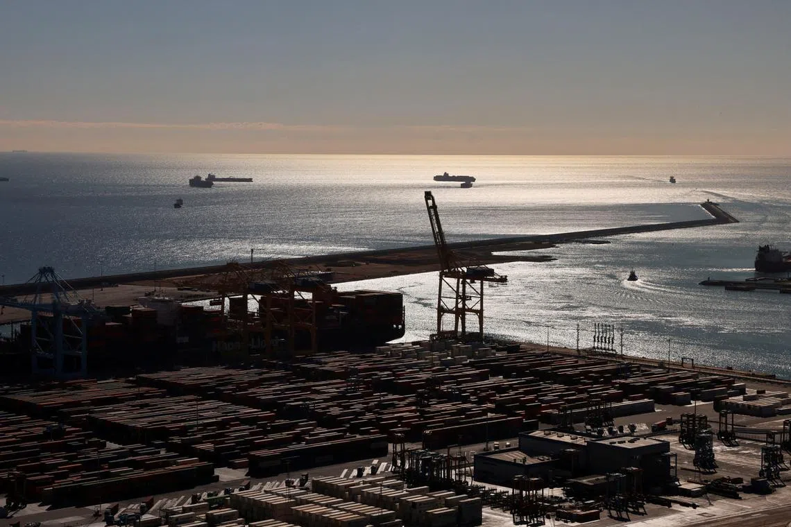 FILE PHOTO: Shipping containers move at the port of Barcelona, after stevedores' union has refused to load and unload any military material amid the war in Gaza and urged the protection of civilian populations in areas of conflict, in Barcelona, Spain, November 7, 2023. REUTERS/Nacho Doce/File Photo