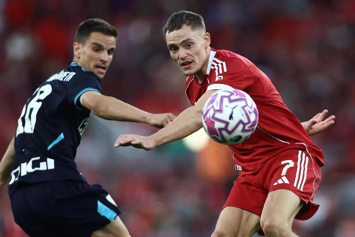 Liverpool's Florian Wirtz (right) in action with Athletic Bilbao's Inigo Ruiz de Galarreta during the Reds' 3-2 friendly win at Anfield on Aug 4, 2025.