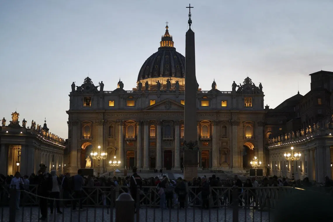 Attendees of a rosary for Pope Francis leave, following the death of the pontiff, with St. Peter's Basilica in the background, in the Vatican, April 21, 2025. REUTERS/Kai Pfaffenbach