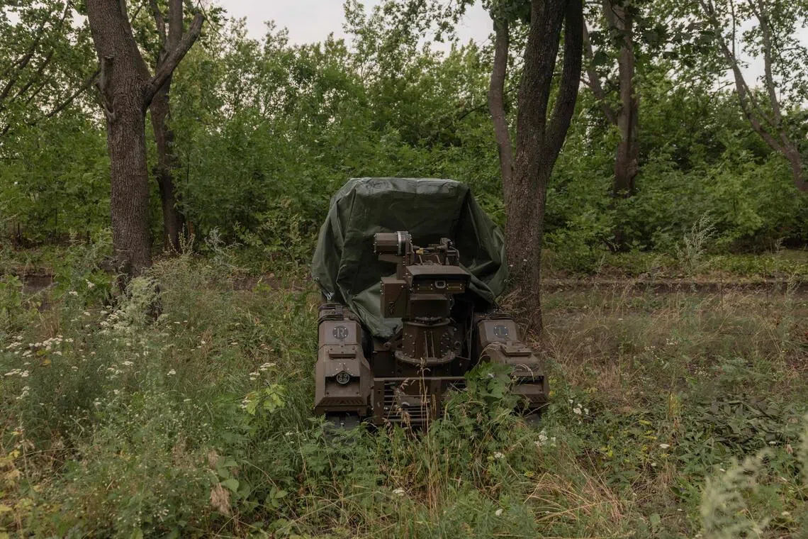 Ukrainian soldiers testing a Droid NW 40 unmanned ground combat vehicle at an undisclosed location in July 2026.