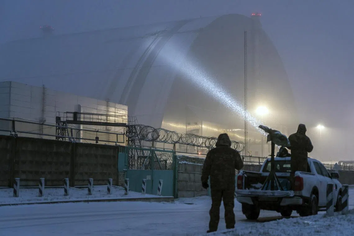 A Ukrainian air defence unit illuminating a hole in the steel shield at the Chernobyl nuclear power plant in Ukraine, on Feb 14.