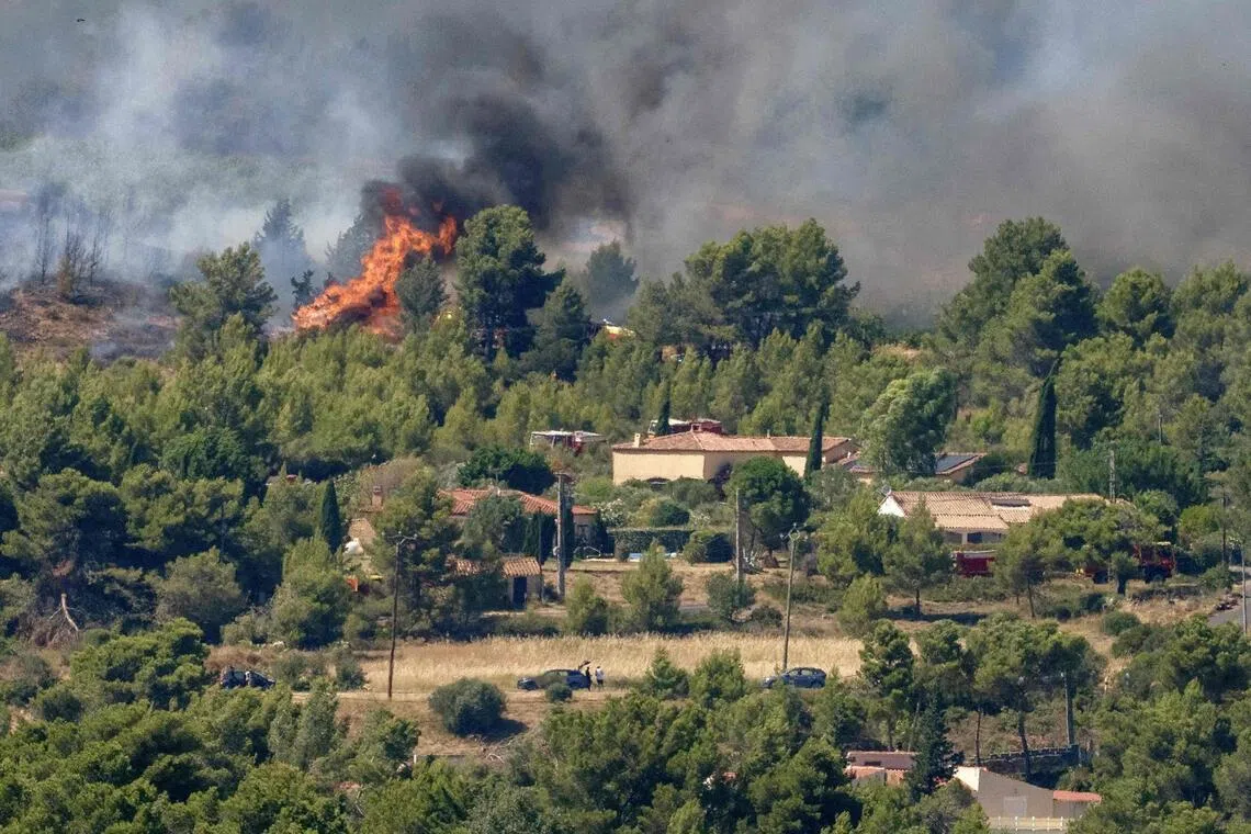 A wildfire raging near houses in Pouzols-Minervois, south-west France, on July 2.