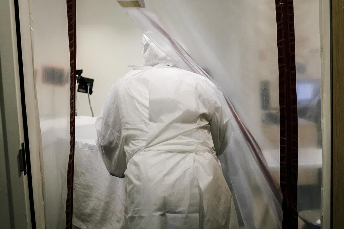 A hospital morgue worker prepares to move the body of a Covid-19 patient, in Los Angeles in this Jan 18, 2021 file photo.