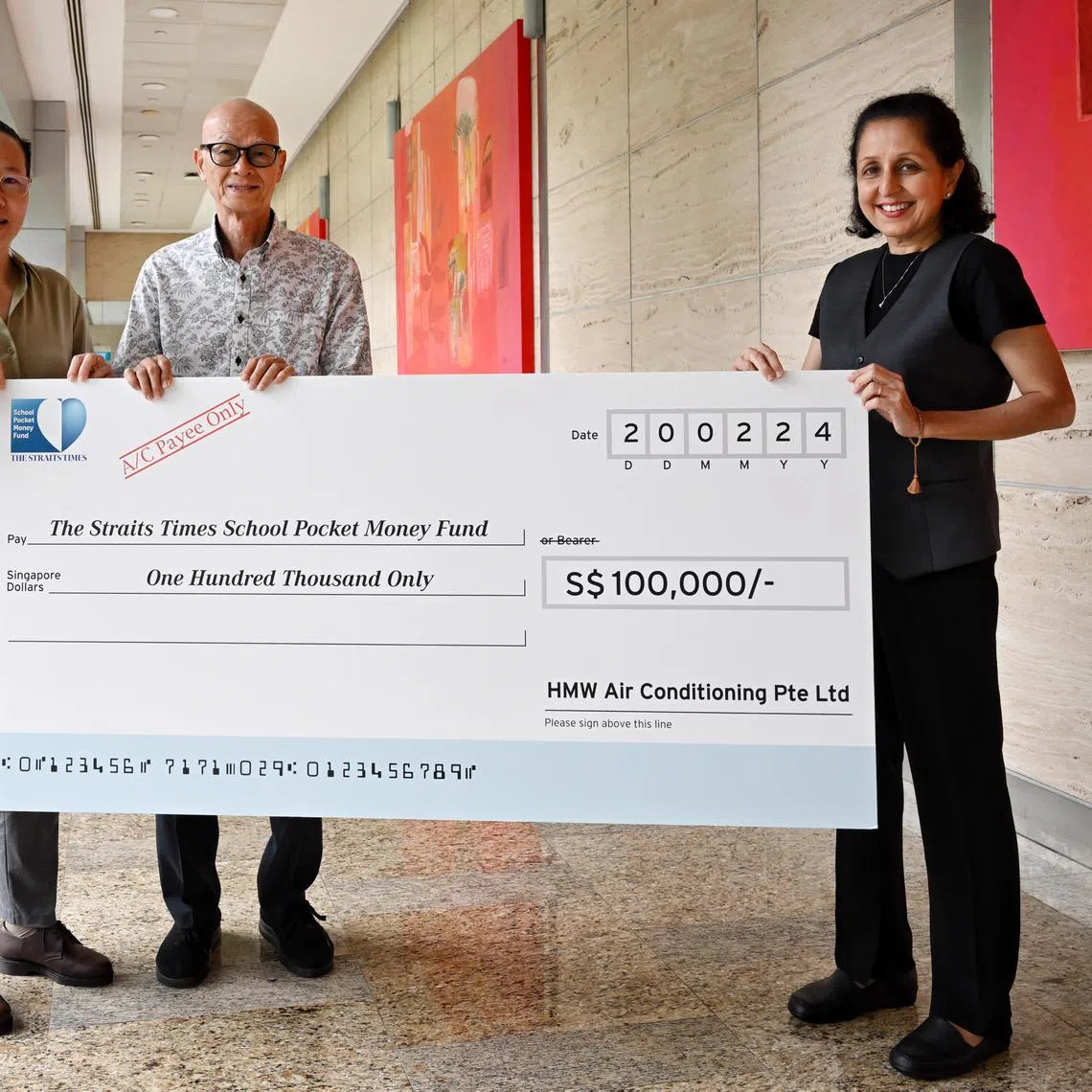 ST20240220_202413452594 Kua Chee Siong/ gymoneyfund20/ In commemoration of HMW Air Conditioning Pte Ltd's 20th anniversary this year, Mr Ho Mun Weng and Ms Ng Ai Yen, the directors of the company, decided to donate $100,000 to The Straits Times School Pocket Money Fund. 
A mock cheque is presented to news editor Karamjit Kaur, at SPH News Centre on Feb 20, 2024.