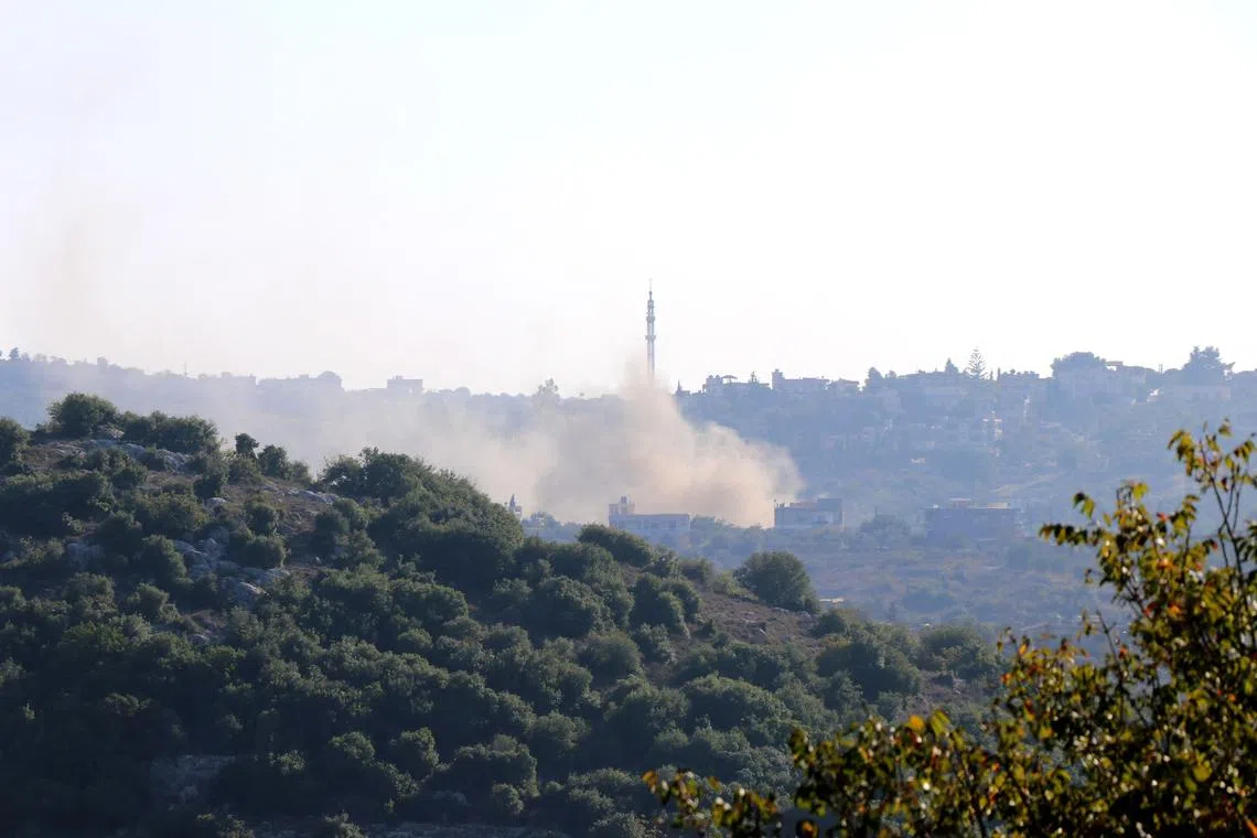 Smoke ascends after an Israeli shell landed on the outskirts of the Lebanese village of Dhayra.