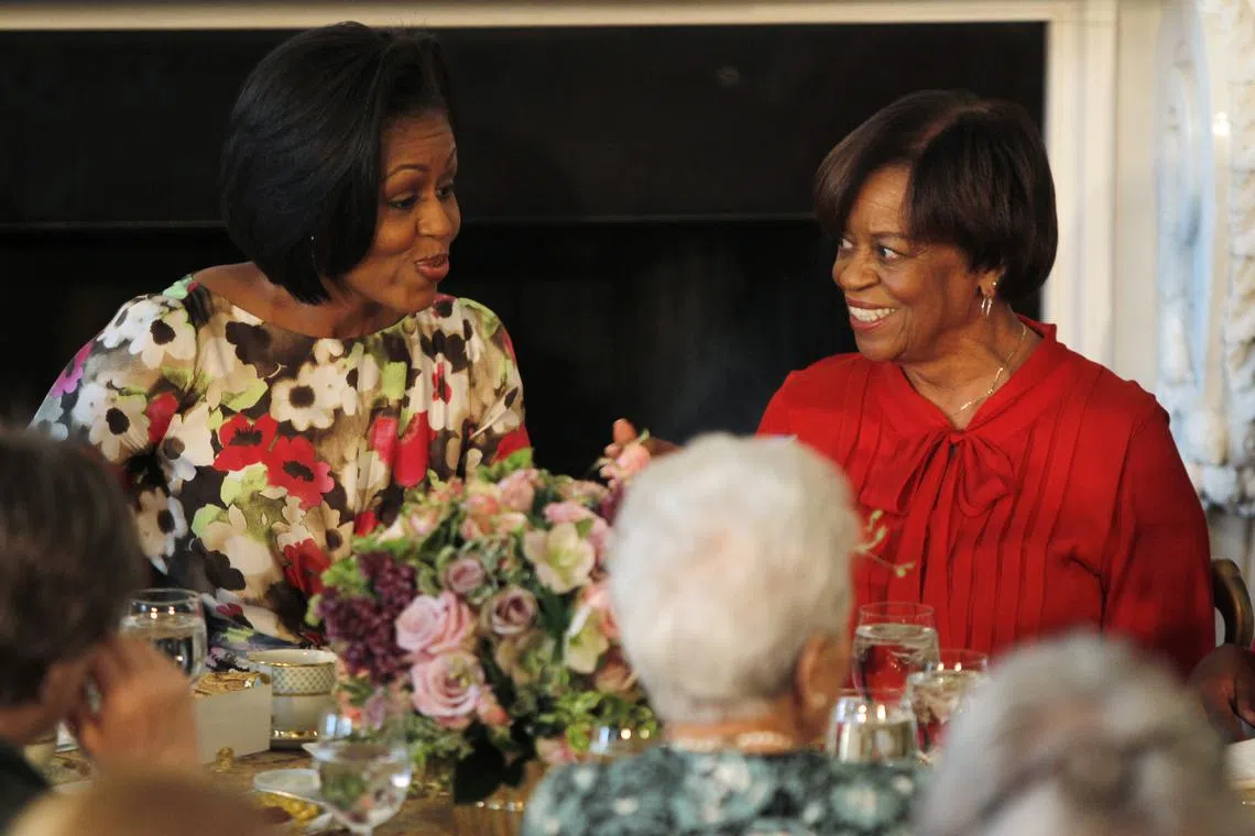 FILE PHOTO: U.S. first lady Michelle Obama (L) sits alongside her mother Marian Robinson as she hosts a Mother's Day event in the State Dining Room of the White House in Washington May 7, 2010. REUTERS/Jason Reed/File Photo