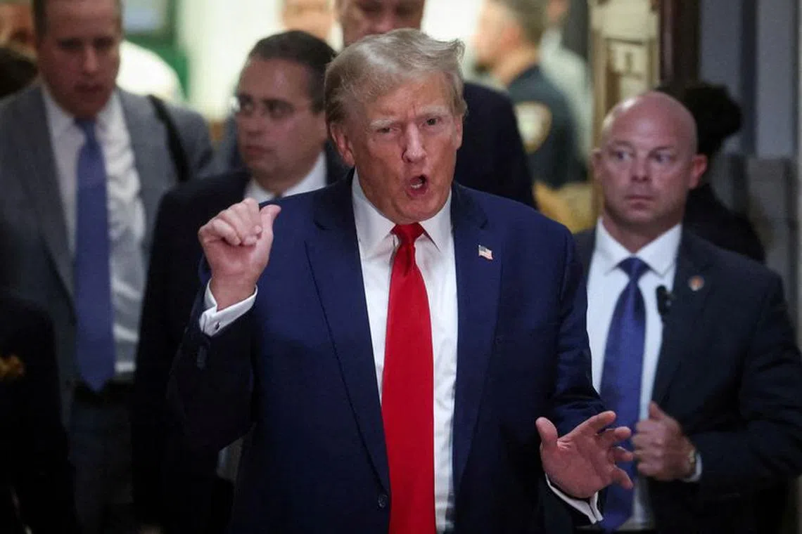 FILE PHOTO: Former U.S. President Donald Trump gestures while leaving the courtroom during a break, as he attends the Trump Organization civil fraud trial, in New York State Supreme Court in the Manhattan borough of New York City, U.S., December 7, 2023. REUTERS/Mike Segar/File Photo