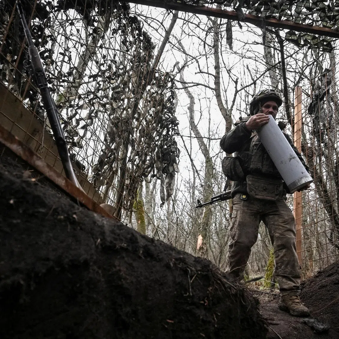 FILE PHOTO: An artilleryman of the 152nd Separate Jaeger Brigade carries a cartridge for a howitzer after firing towards Russian troops, amid Russia's attack on Ukraine, near the frontline town of Pokrovsk in Donetsk region, Ukraine December 11, 2025. REUTERS/Stringer/File Photo