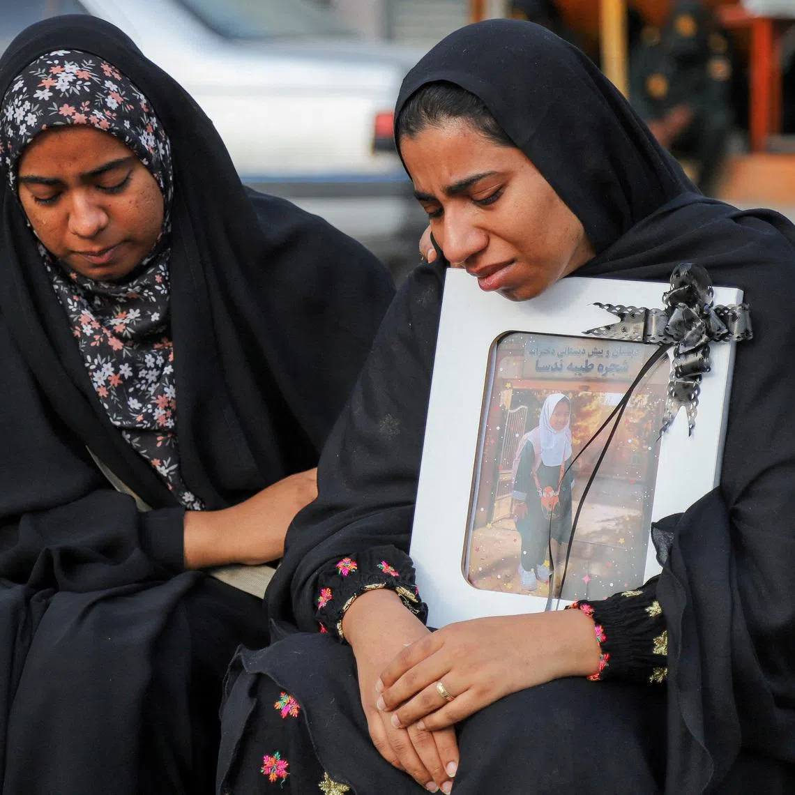 People mourn on the day of the funeral of the victims on March 3, following an Israeli strike on a school, in Minab, Iran.