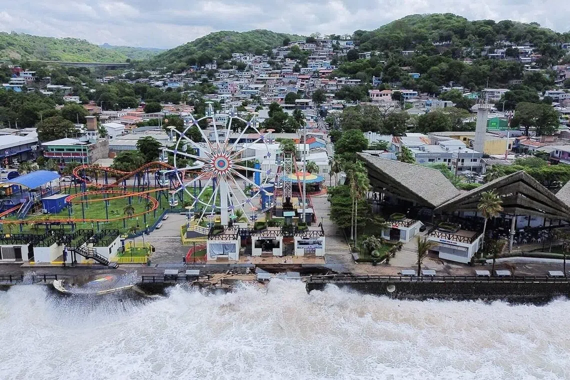 Waves hitting a boardwalk closed due to swells as Tropical Storm Cristina approaches, in La Libertad, El Salvador, June 9.