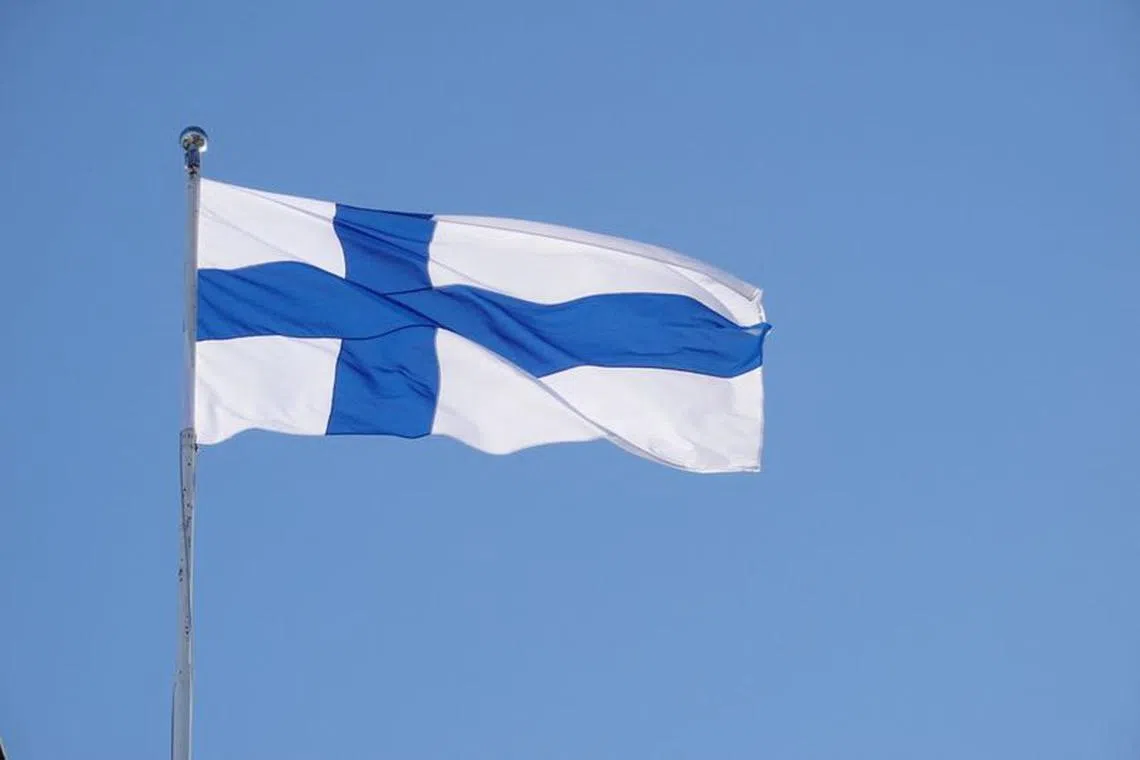 FILE PHOTO: The Finnish flag flutters outside the city hall, as Finland becomes a member of NATO, in Helsinki, Finland, April 4, 2023. REUTERS/Tom Little/File Photo
