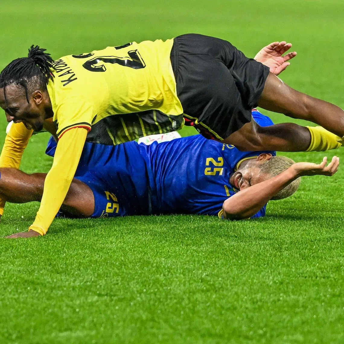 Uganda defender Aziz Kayondo falling on Tanzania midfielder Haji Mnoga after clashing in the Africa Cup of Nations (CAN) Group C football match at Al Medina Stadium in Rabat on Dec 27, 2025.