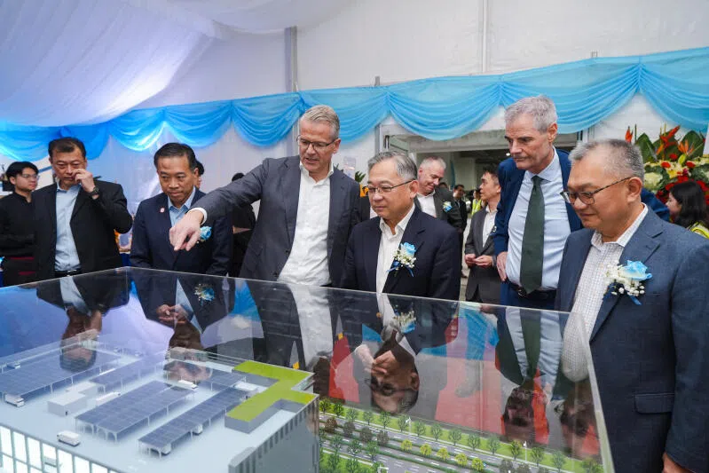 DPM Gan Kim Yong with EDB chairman Png Cheong Boon (2nd from left) and AP Moller-Maersk chief executive Vincent Clerc (3rd from left), looking at a model of World Gateway II, a $200 million facility designed to help companies store and ship goods.