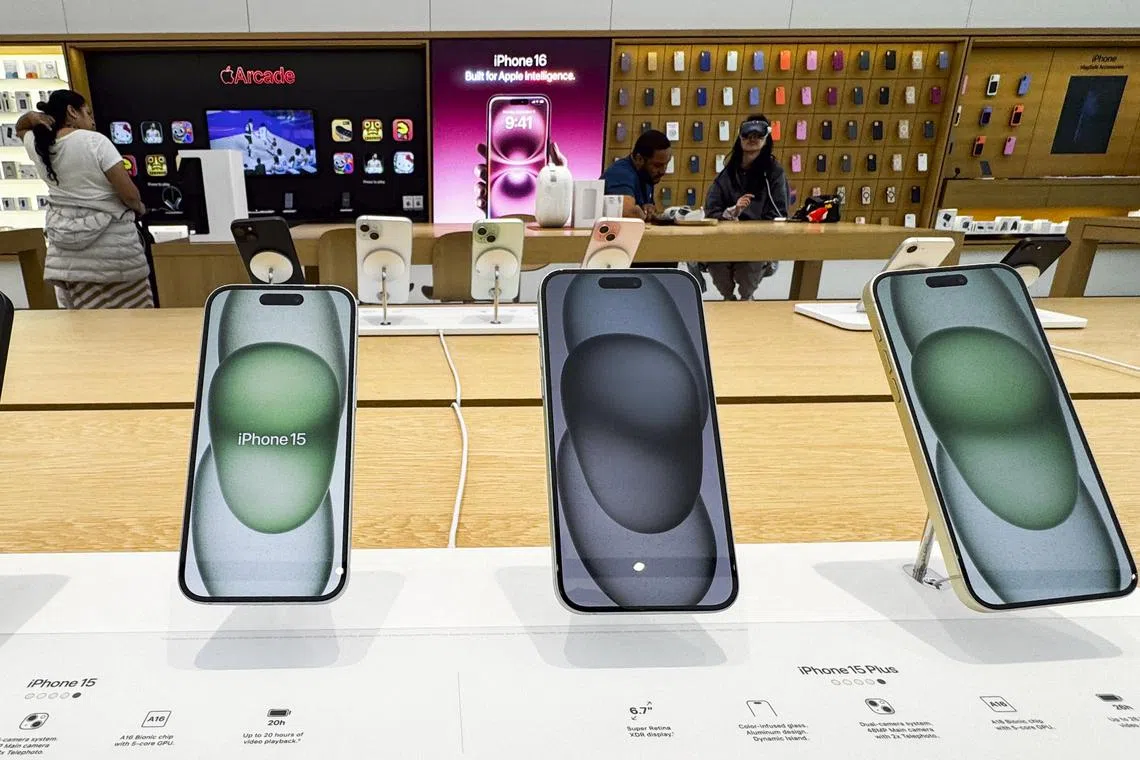 Apple iPhones are displayed in a store in Washington, DC, on April 08, 2025. China vowed April 8, 2025 to "fight to the end" after US President Donald Trump threatened to further ramp up tariffs but the EU warned against escalating a trade war that has rocked global markets. Trump has upended the world economy with sweeping tariffs that have raised the spectre of an international recession, but has ruled out any pause in his aggressive trade policy despite a dramatic market sell-off. (Photo by Roberto SCHMIDT / AFP)