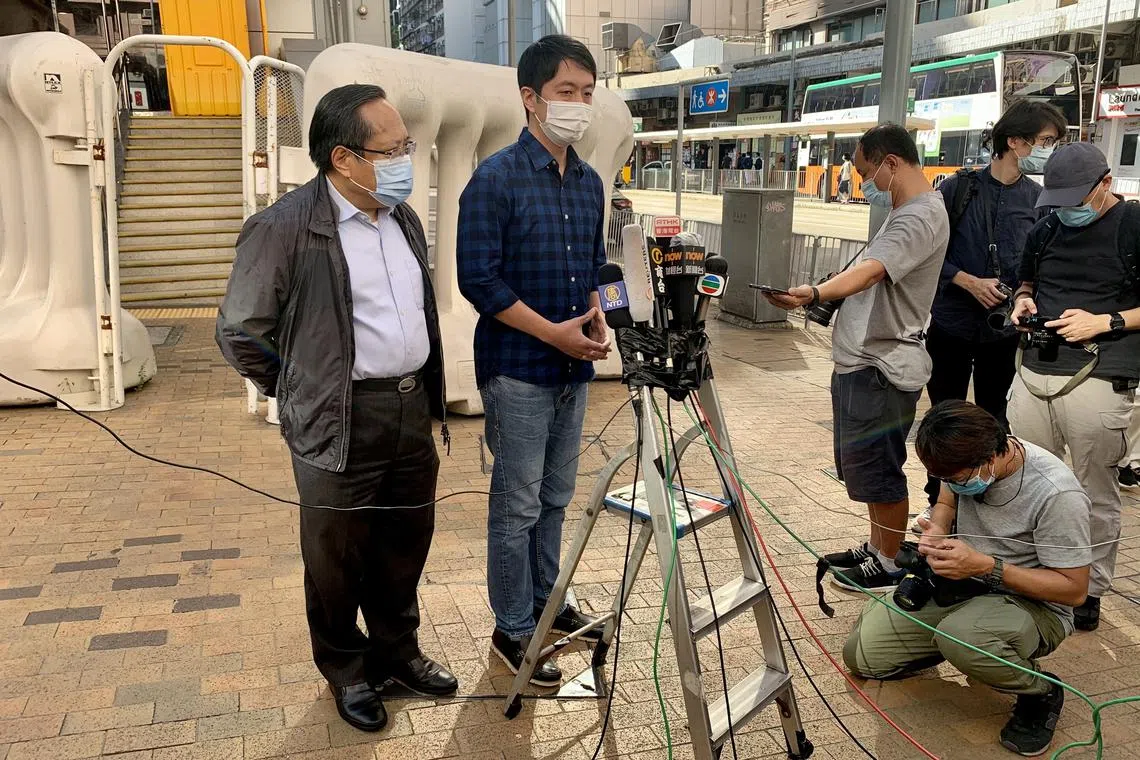 Former lawmaker Ted Hui Chi-fung speaks to members of the media after he was released on bail, next to Albert Ho, outside Western Police Station in Hong Kong, China November 18, 2020. REUTERS/Yoyo Chow/File Photo