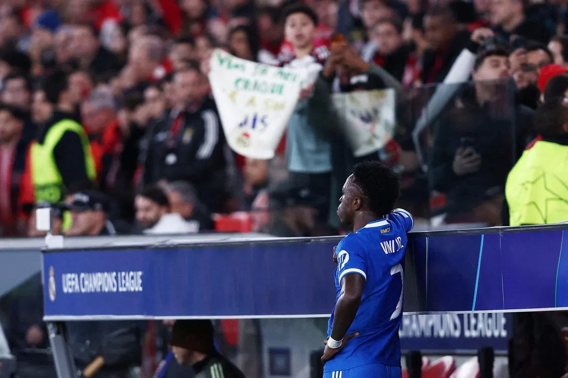 Soccer Football - UEFA Champions League - Play Off - First Leg - Benfica v Real Madrid - Estadio da Luz, Lisbon, Portugal - February 17, 2026 Real Madrid's Vinicius Junior looks on from the side of the pitch as the match was stopped due to racist chants REUTERS/Rodrigo Antunes