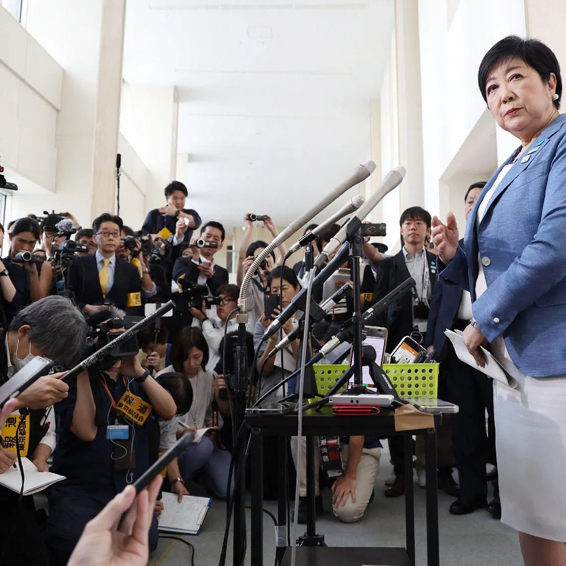 Tokyo Governor Yuriko Koike (R) speaks to the media in the Shinjuku area of Tokyo on June 12, 2024, after announcing she would run for a third four-year term ahead of the planned July 7 gubernatorial election. (Photo by JIJI Press / AFP) / Japan OUT