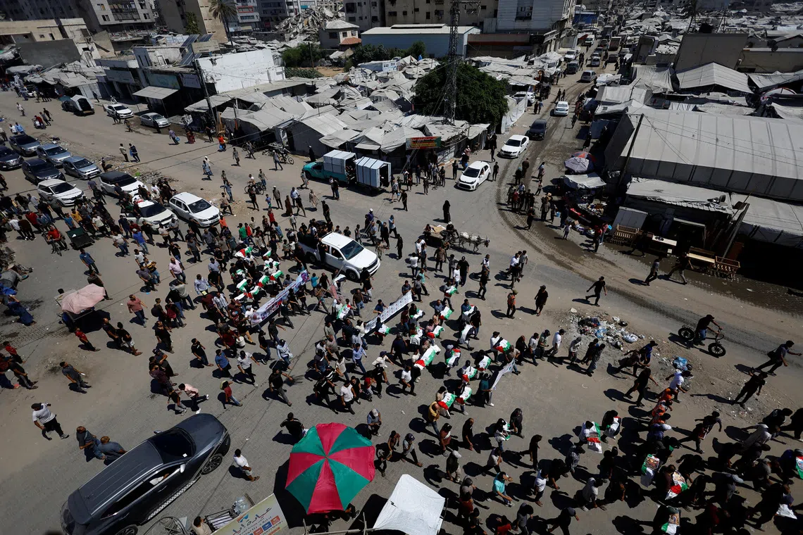 Palestinians attend the funeral of 50 people from three families killed during the war and whose bodies were retrieved from under the rubble recently, in Gaza City, August 20, 2026. REUTERS/Mahmoud Issa