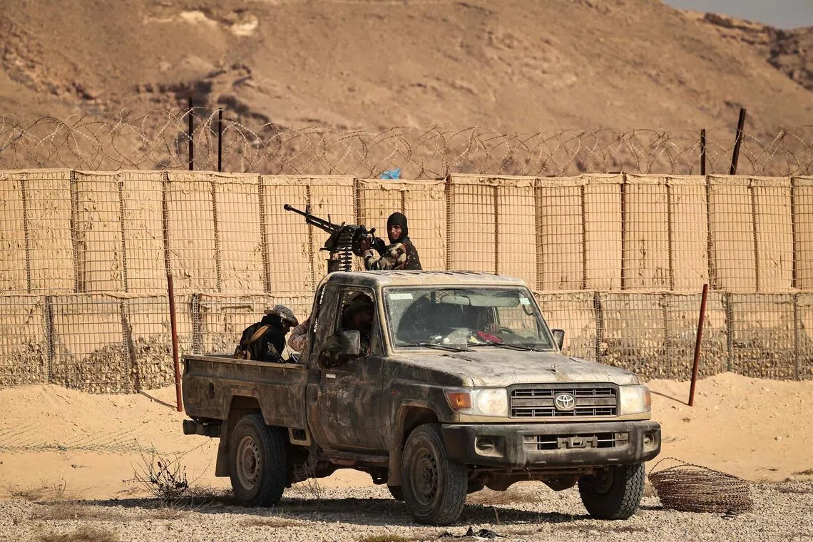 This photograph taken on January 20, 2026 during a tour for the foreign media organised by the Saudi-backed Yemeni government shows Saudi-backed Yemeni forces in the city of Mukalla in Yemen's coastal southern Hadramawt province. Saudi-backed Yemeni officials on January 19 said the United Arab Emirates has been running secret prisons in the country's south, the latest episode in a growing rift between the two regional allies turned rivals. The UAE and Saudi Arabia entered the Yemen war in 2015 as a united front backing the government against Iran-backed rebels. But they later supported rival factions within Yemen's internationally recognised government. A brief land grab by UAE-backed separatists infuriated Riyadh, which rolled them back. (Photo by Fadel SENNA / AFP)