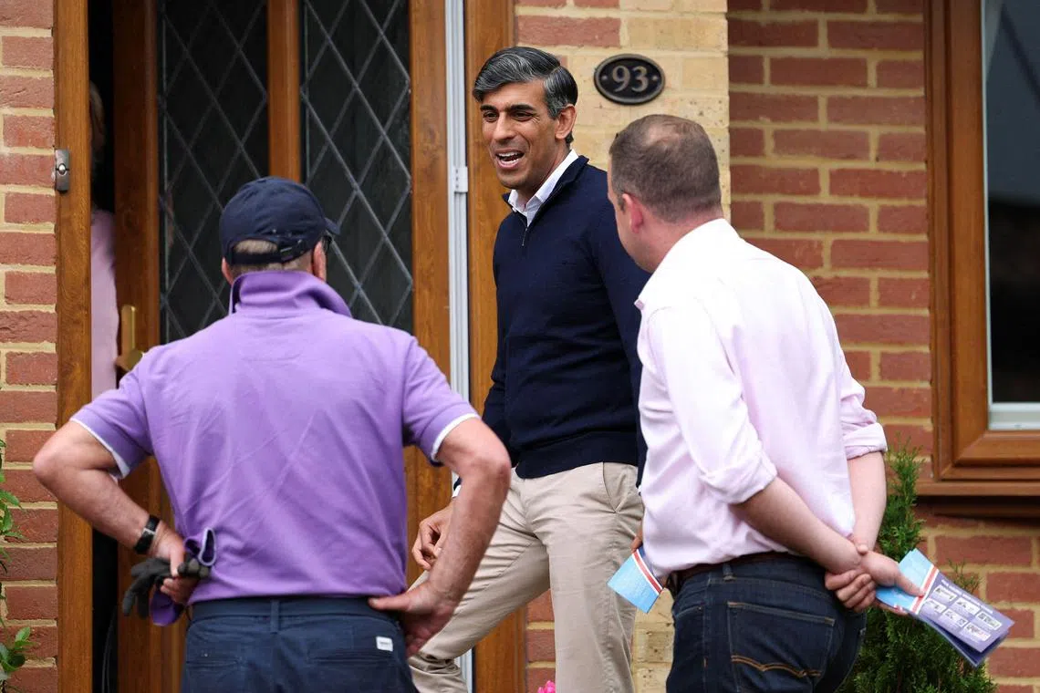 British Prime Minister Rishi Sunak (centre) campaigning in the town of Eastleigh, in southern England, on July 3.